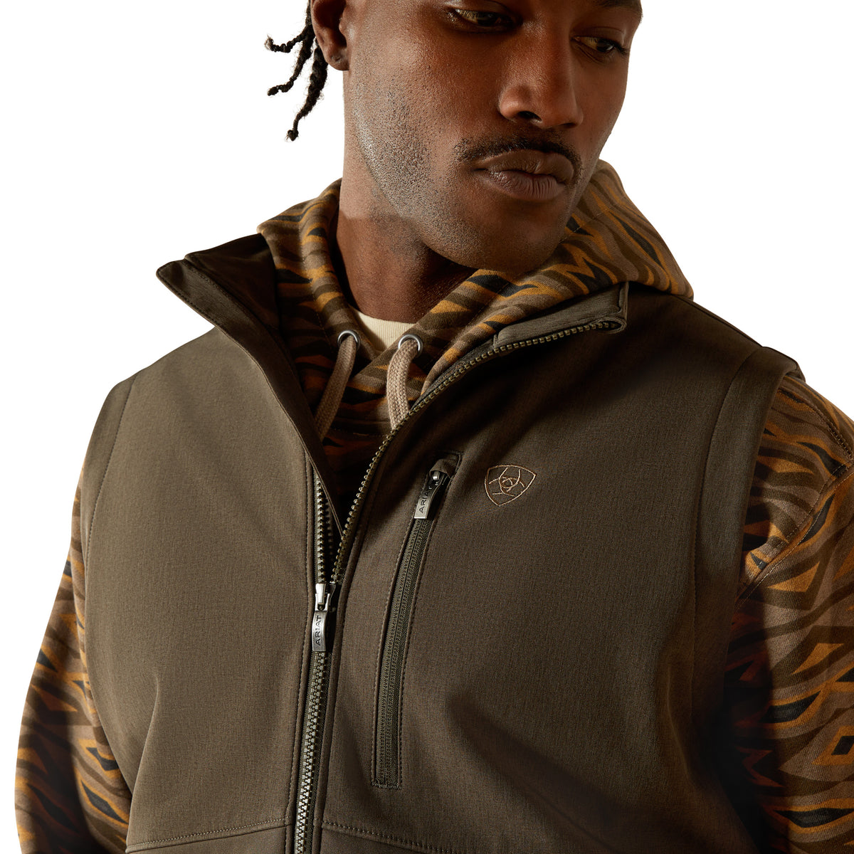 Man wearing a brown jacket with a tiger stripe pattern on a white background