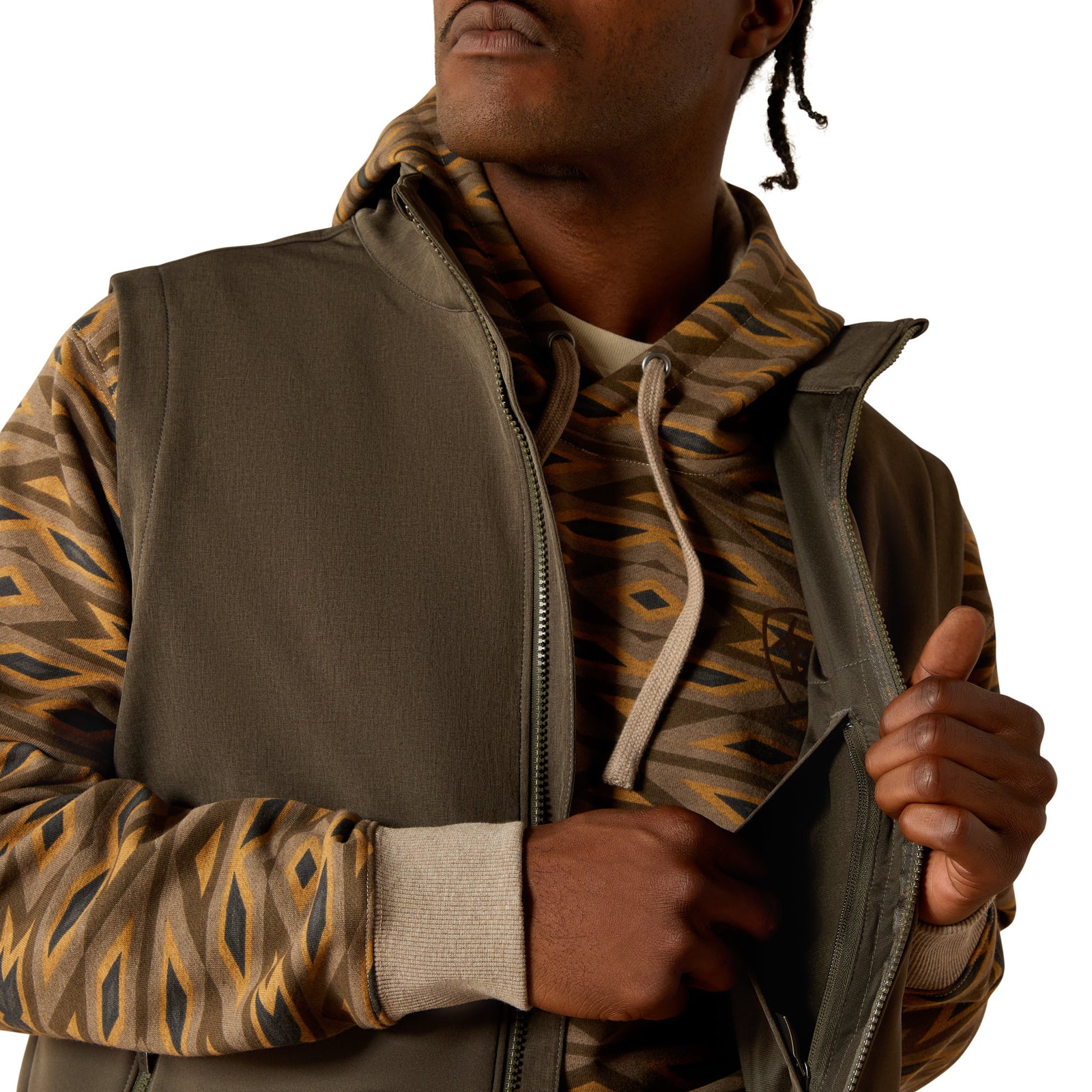 Man wearing a brown and camouflage jacket on a white background
