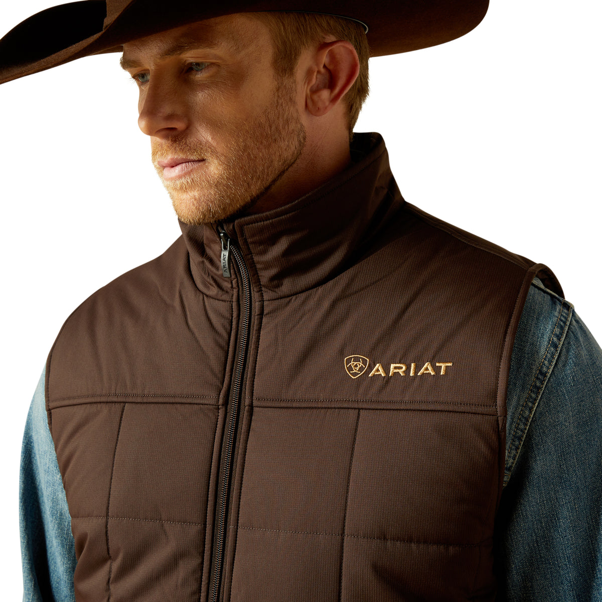 Man wearing a brown Ariat vest and cowboy hat on a white background
