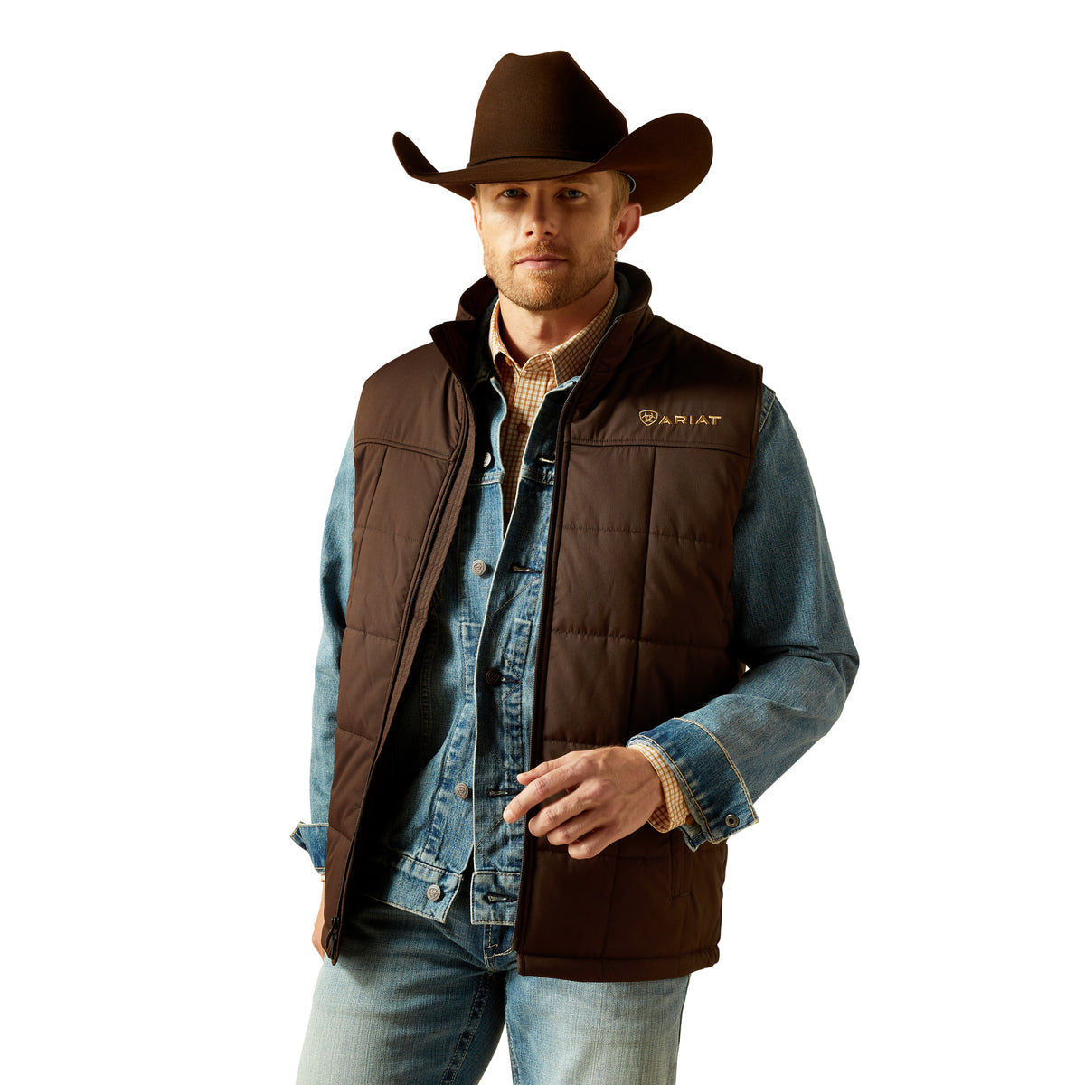 Man wearing a brown vest, denim jacket, and cowboy hat on a white background