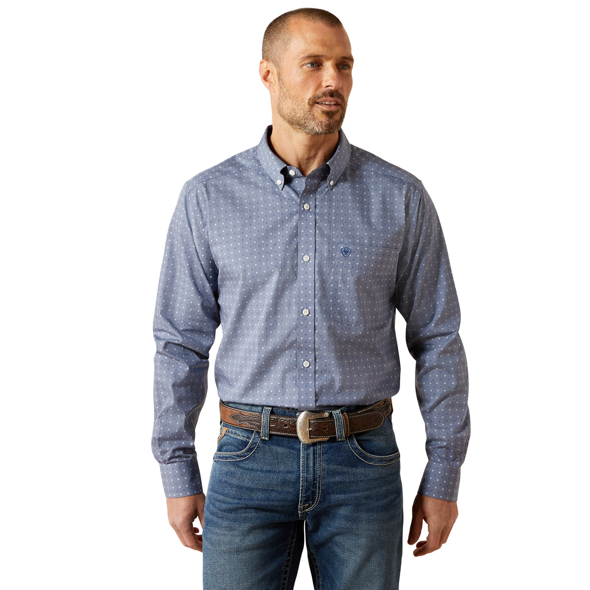 Man wearing a blue patterned shirt and jeans on a white background