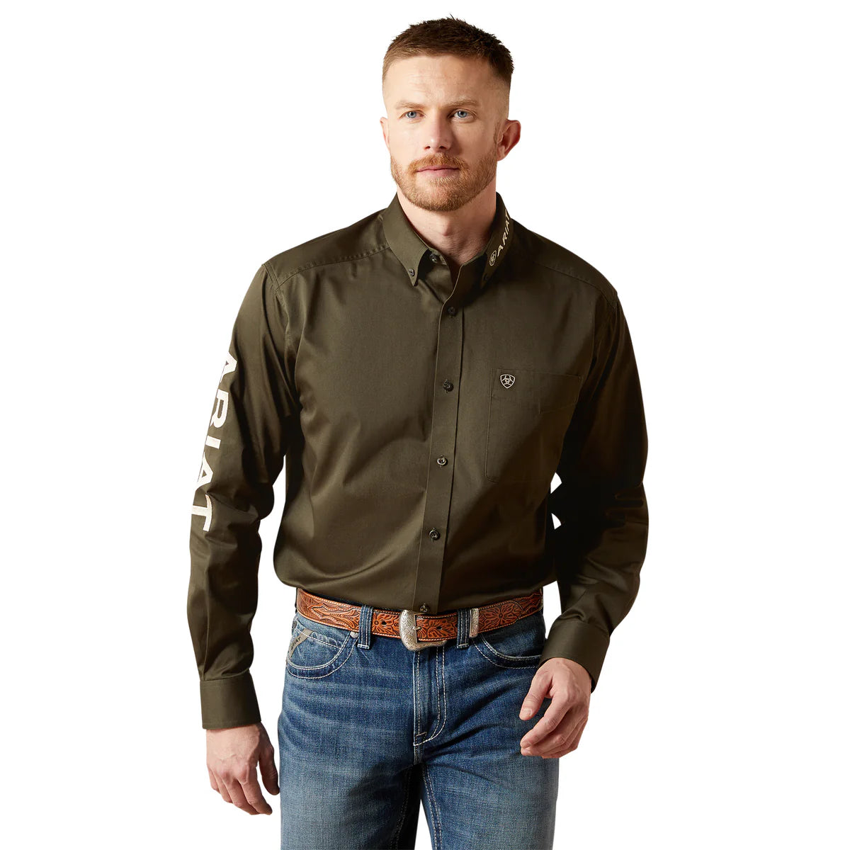 Man wearing a green shirt with a logo and text, standing against a white background
