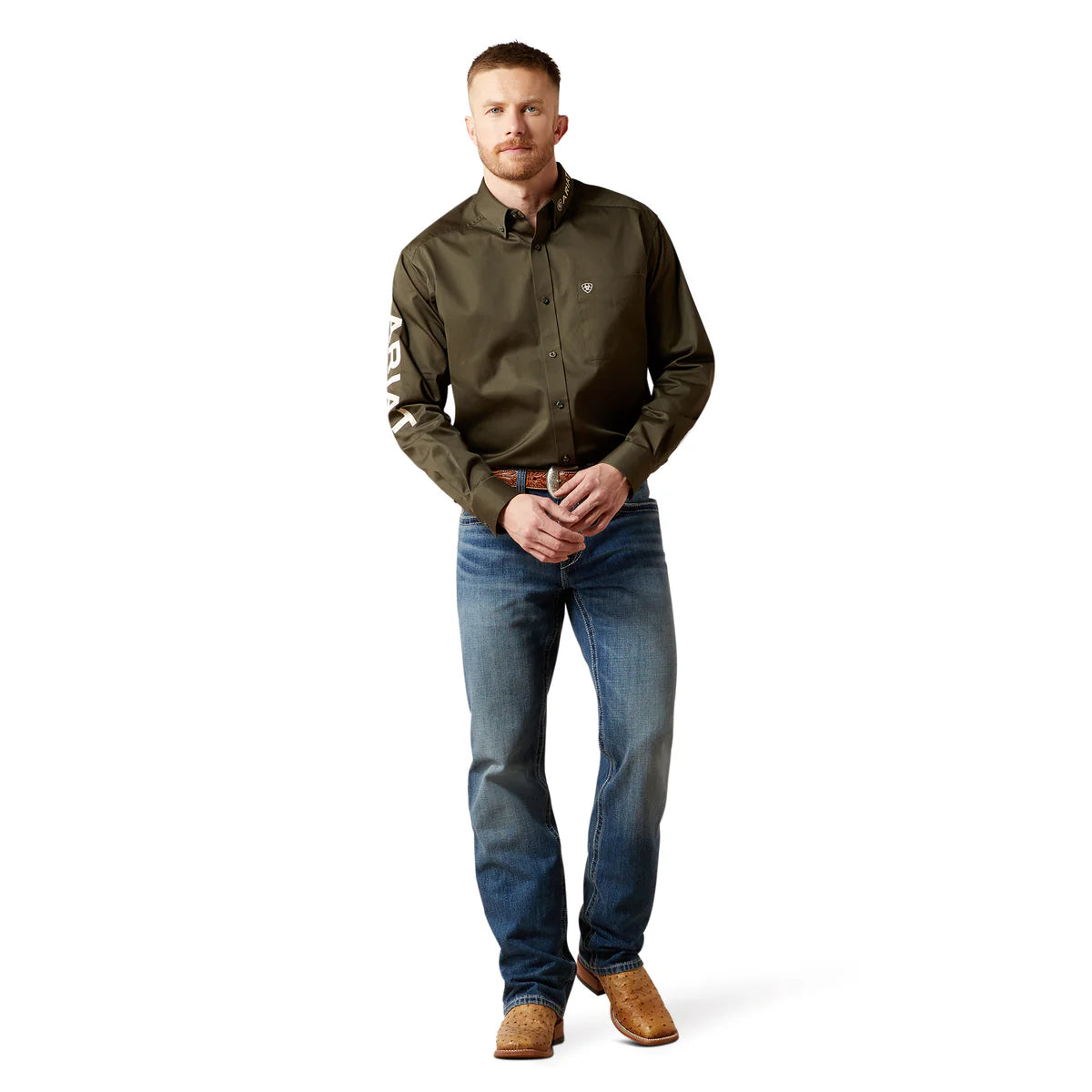 Man wearing a green shirt with a logo, blue jeans, and brown boots on a white background