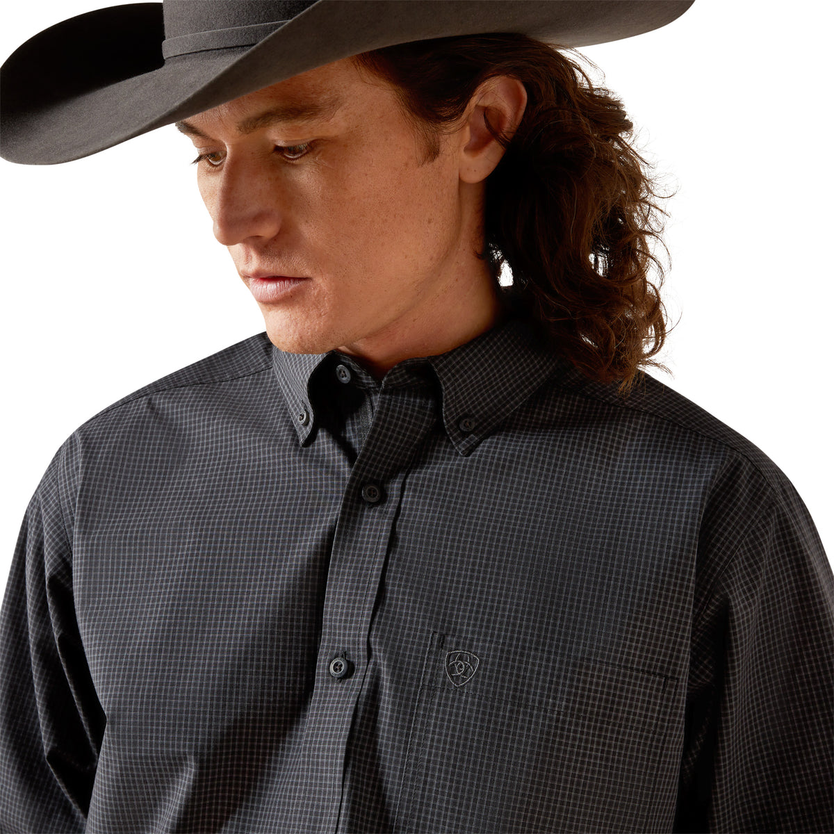 Person wearing a dark gray checkered shirt and cowboy hat on a white background