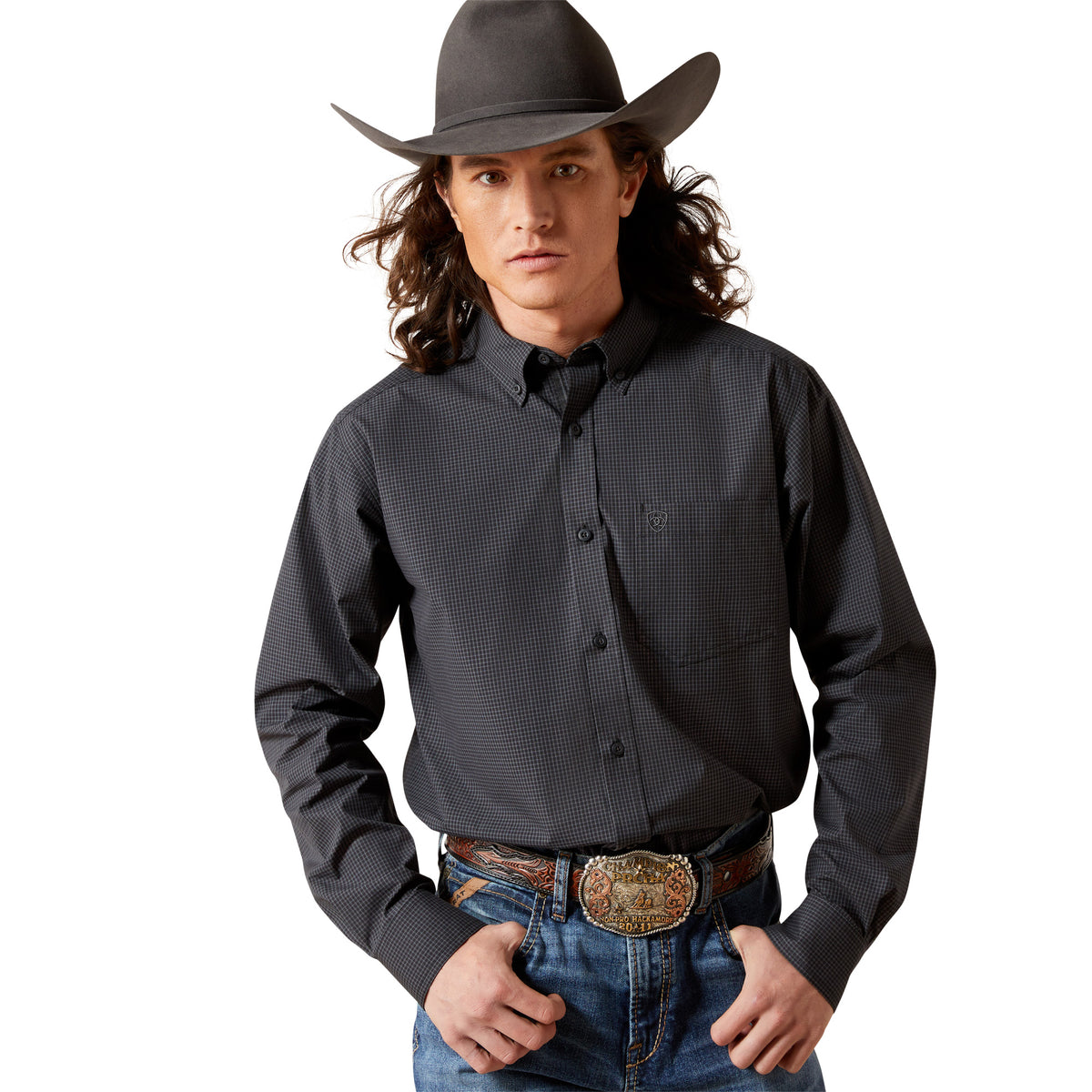 Man wearing a black patterned shirt, blue jeans, and a cowboy hat on a white background
