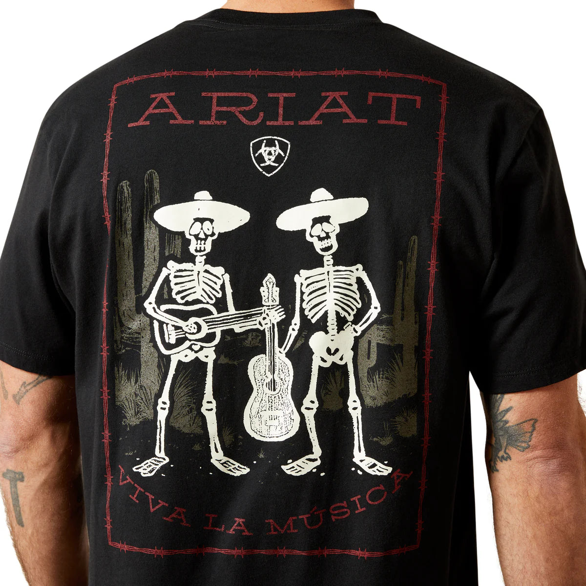 Black t-shirt with skeleton design and 'Ariat' branding on a person wearing it.
