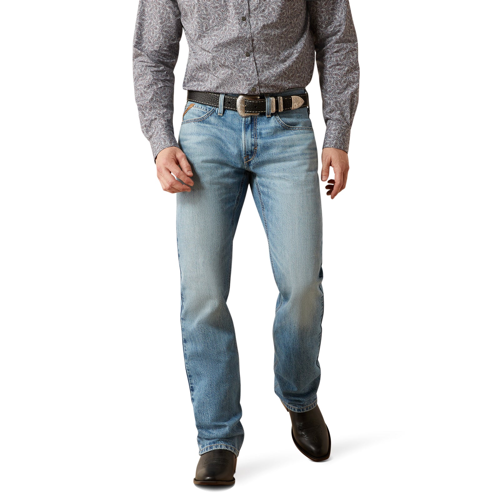 Person wearing light blue jeans and a patterned shirt on a white background