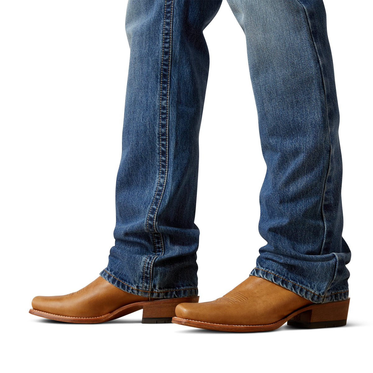 Close-up of blue jeans and brown leather boots on a white background