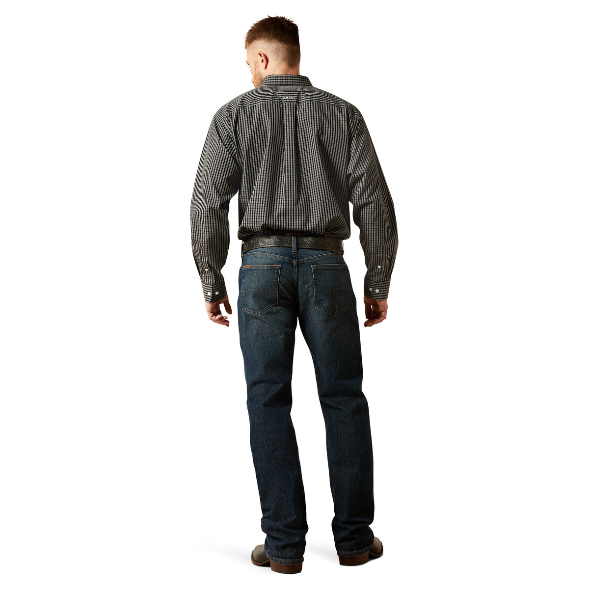 Man wearing a checkered shirt and jeans on a white background