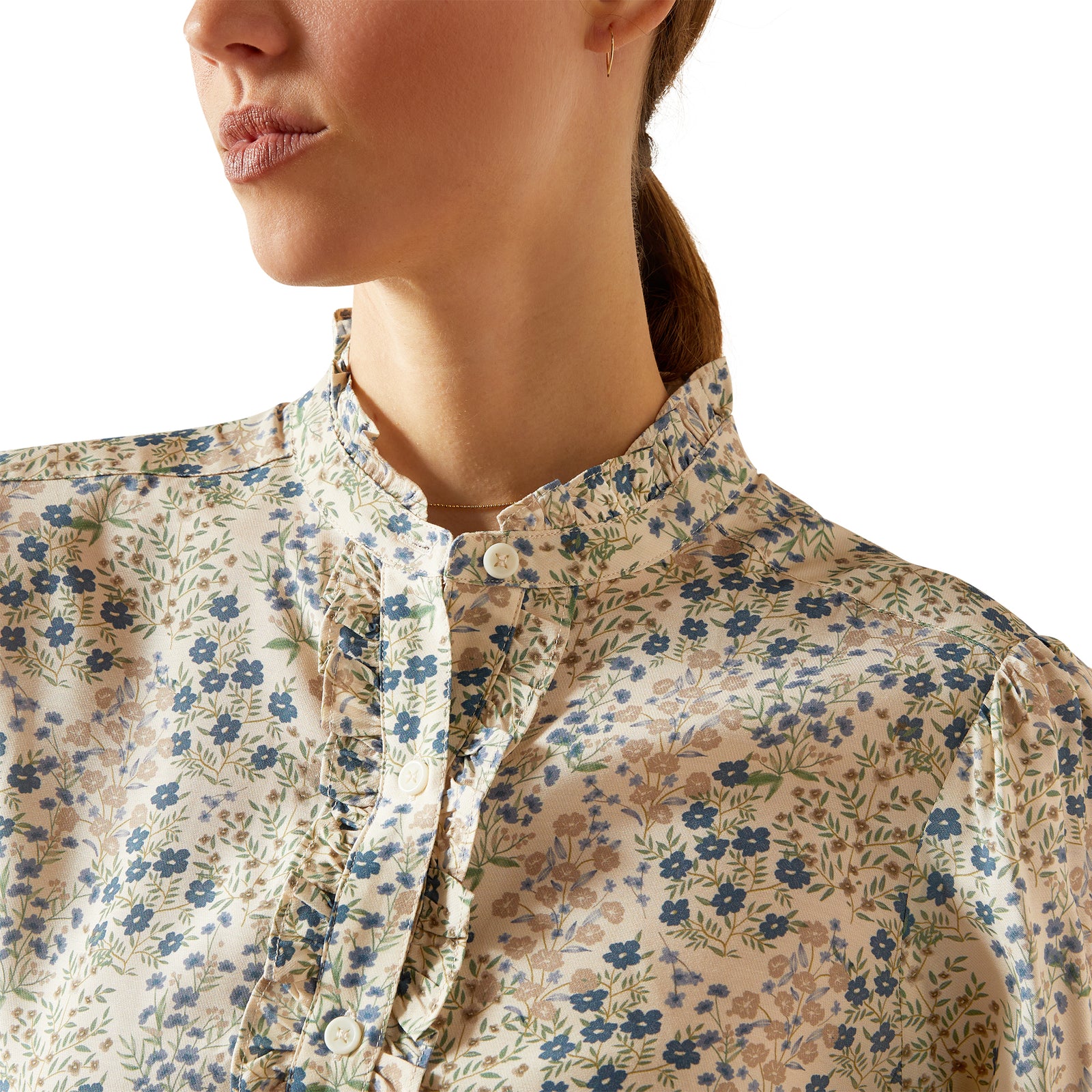 Woman wearing a floral blouse with long sleeves on a white background