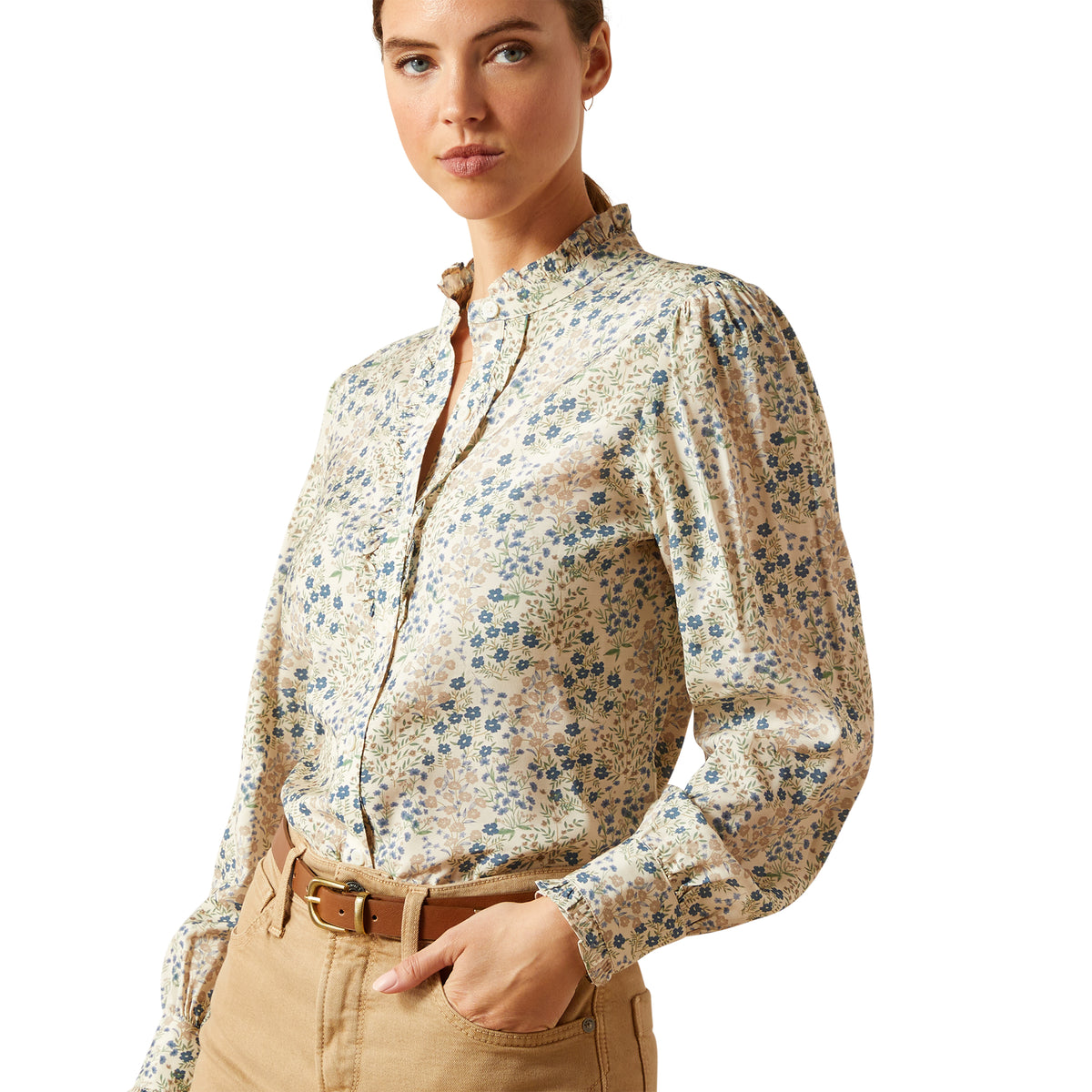 Woman wearing a floral blouse with long sleeves on a white background