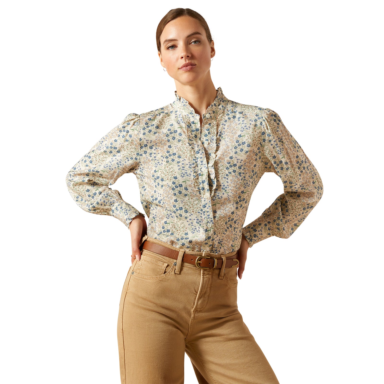 Woman wearing a floral blouse and beige pants on a white background