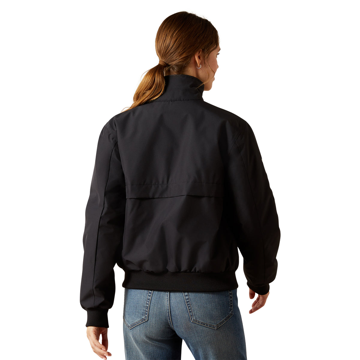 Person wearing a black jacket and blue jeans on a white background