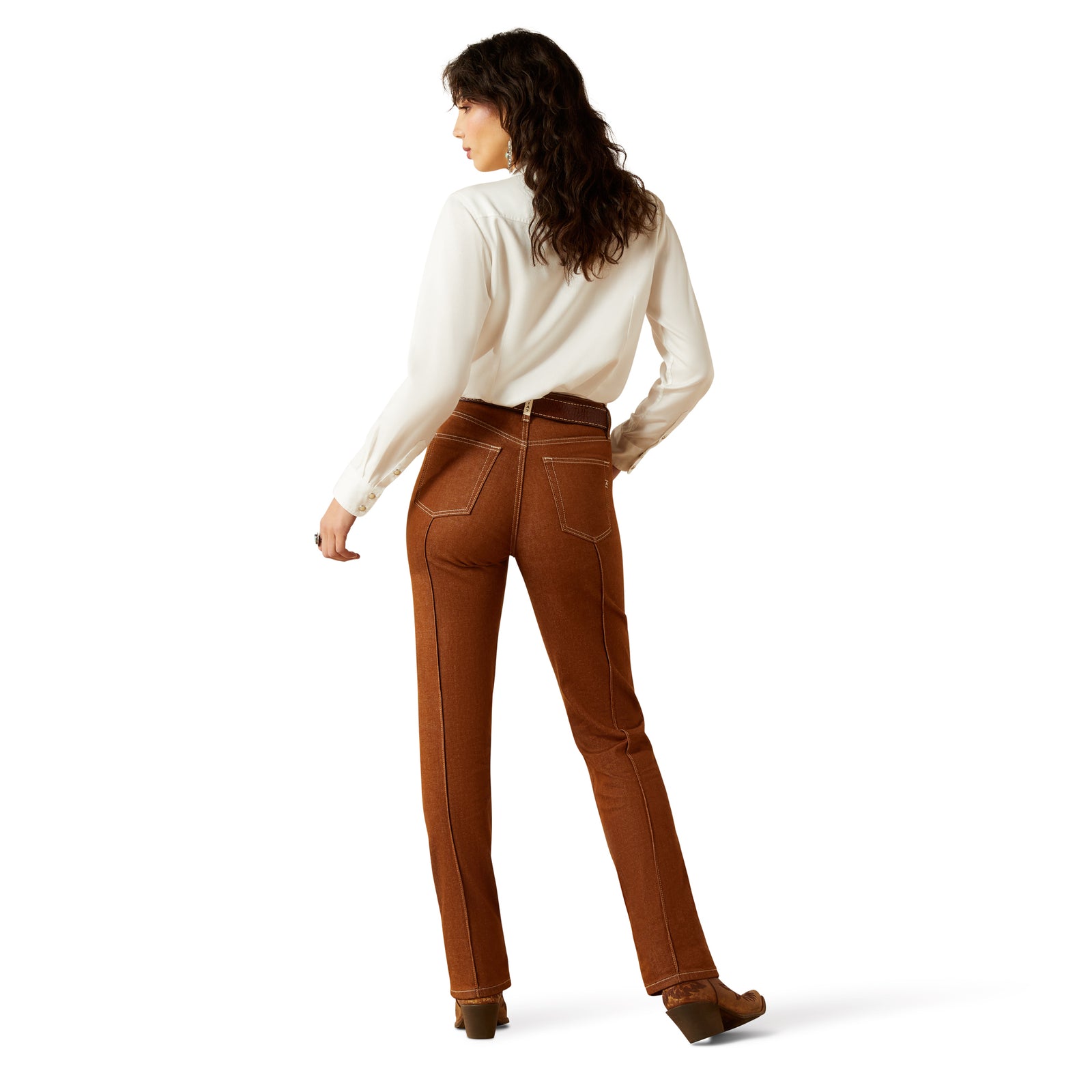 Ariat Women's Jazmine Ultra High Rise Relaxed Straight Jean. Woman wearing brown pants and a white shirt on a white background