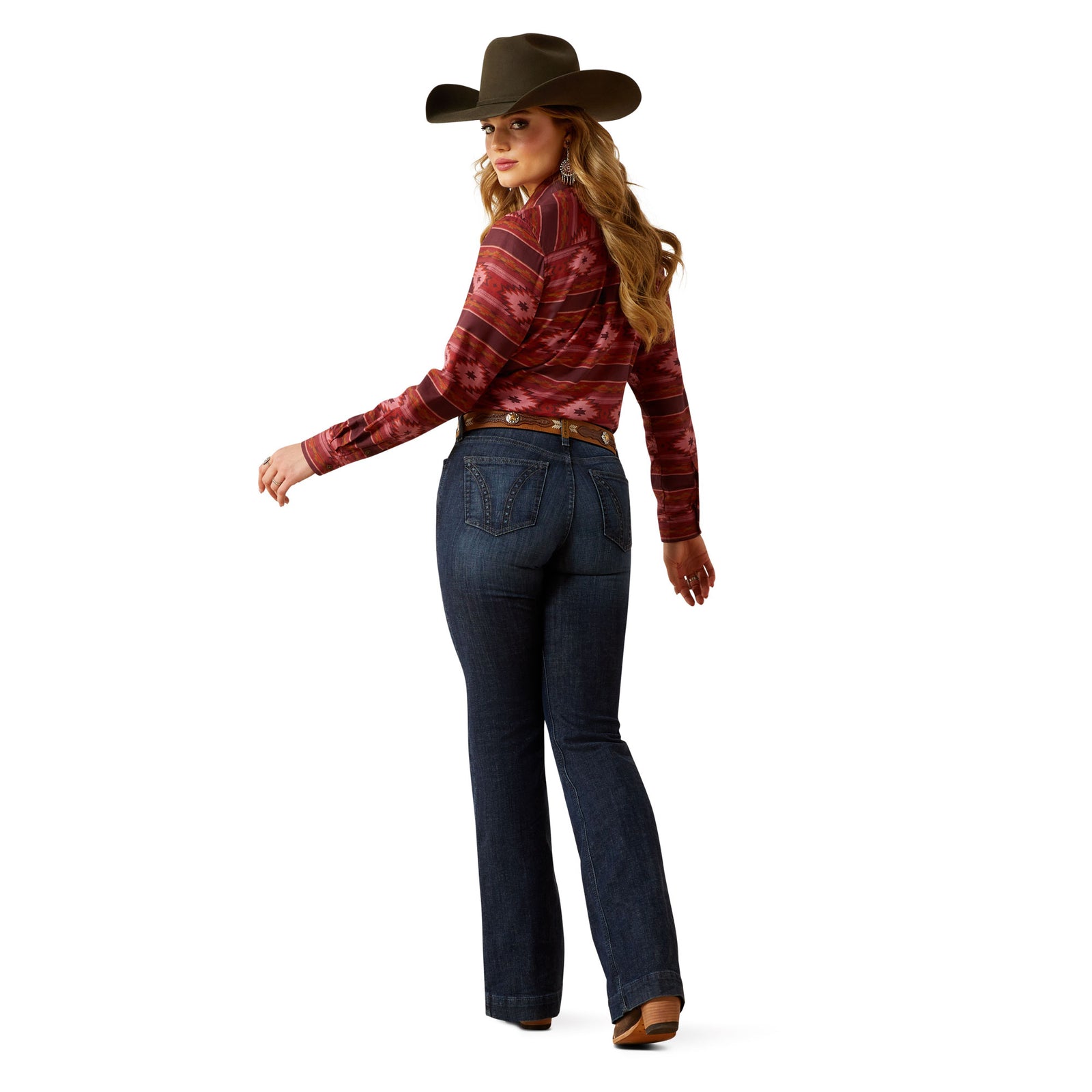 Ariat Women's Frazey High Rise Slim Trouser. Person wearing blue jeans and a patterned shirt on a white background