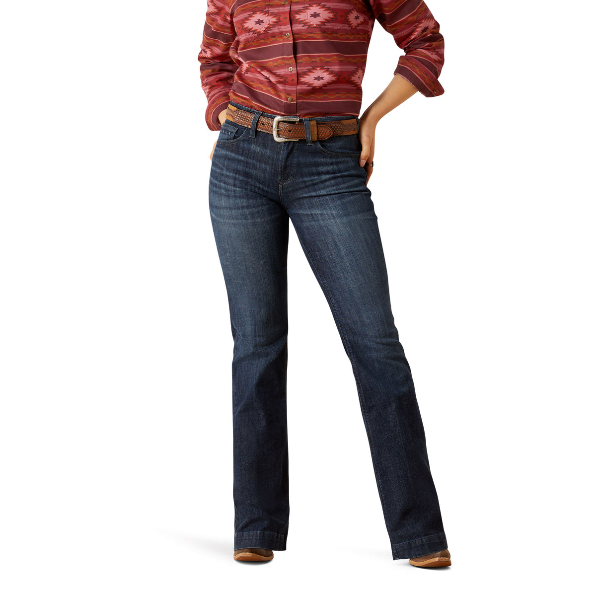 Ariat Women's Frazey High Rise Slim Trouser. Person wearing blue jeans and a patterned shirt on a white background