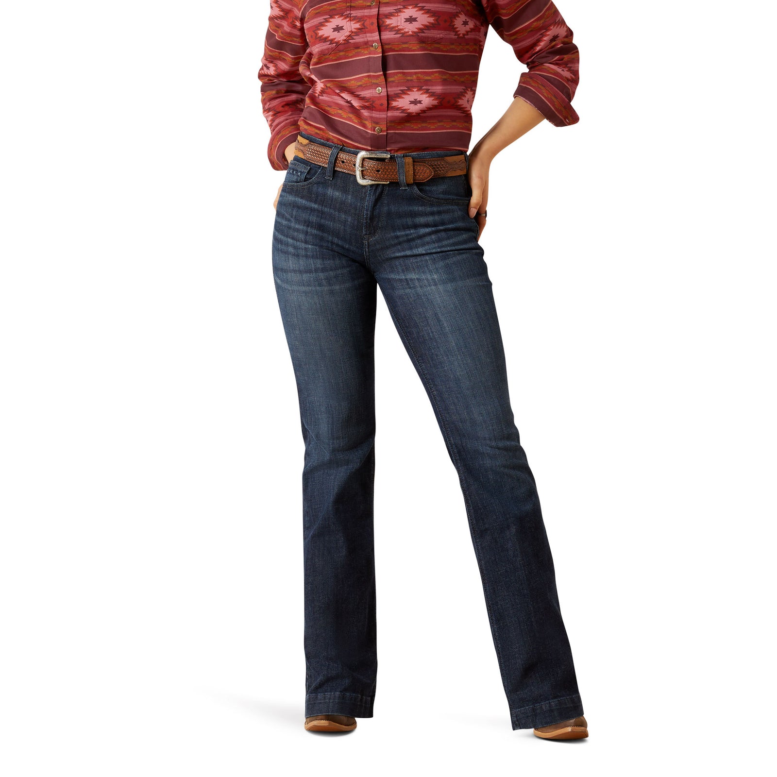 Ariat Women's Frazey High Rise Slim Trouser. Person wearing blue jeans and a patterned shirt on a white background