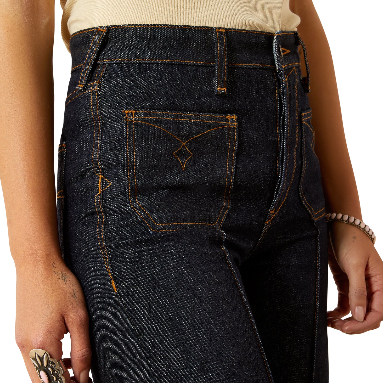 Ariat Women's Western Utility Ultra High Rise Tomboy Wide Leg Jean. Close-up of dark blue jeans with a white background