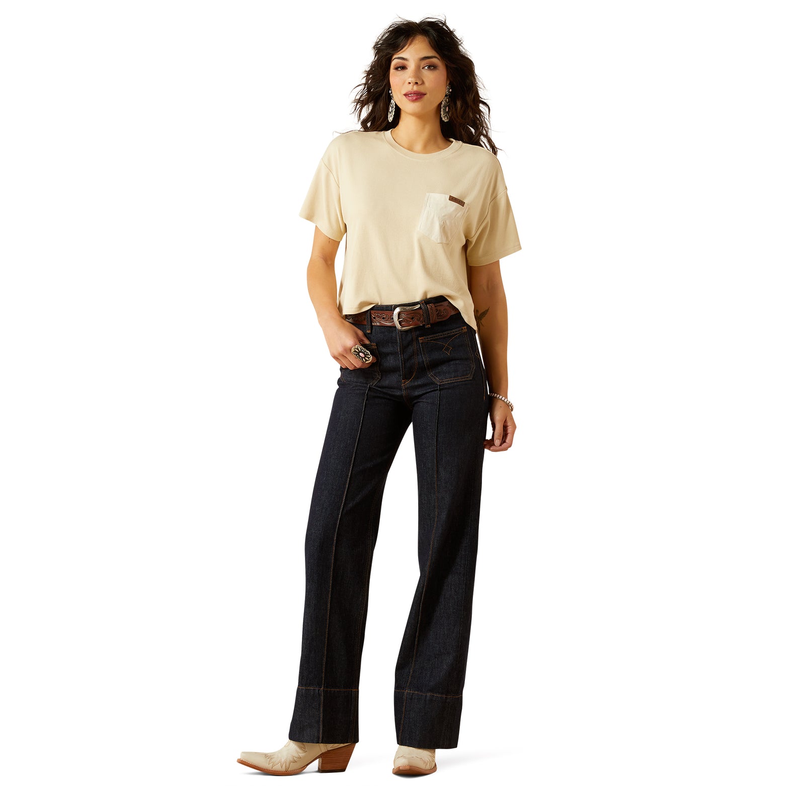 Ariat Women's Western Utility Ultra High Rise Tomboy Wide Leg Jean. Woman wearing a beige t-shirt and dark jeans on a white background