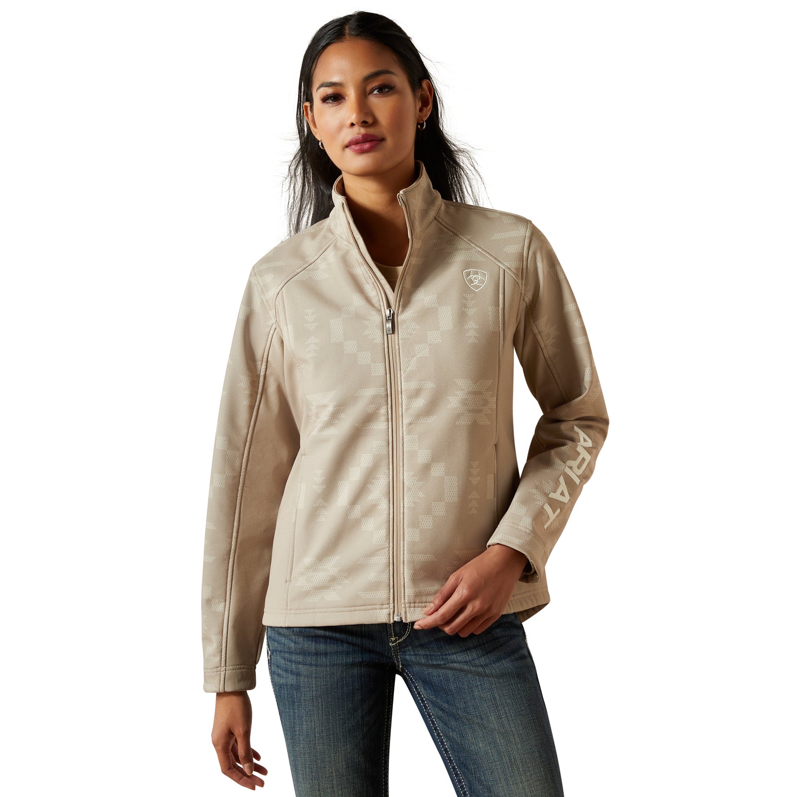 Woman wearing a beige jacket with a brand logo on a white background