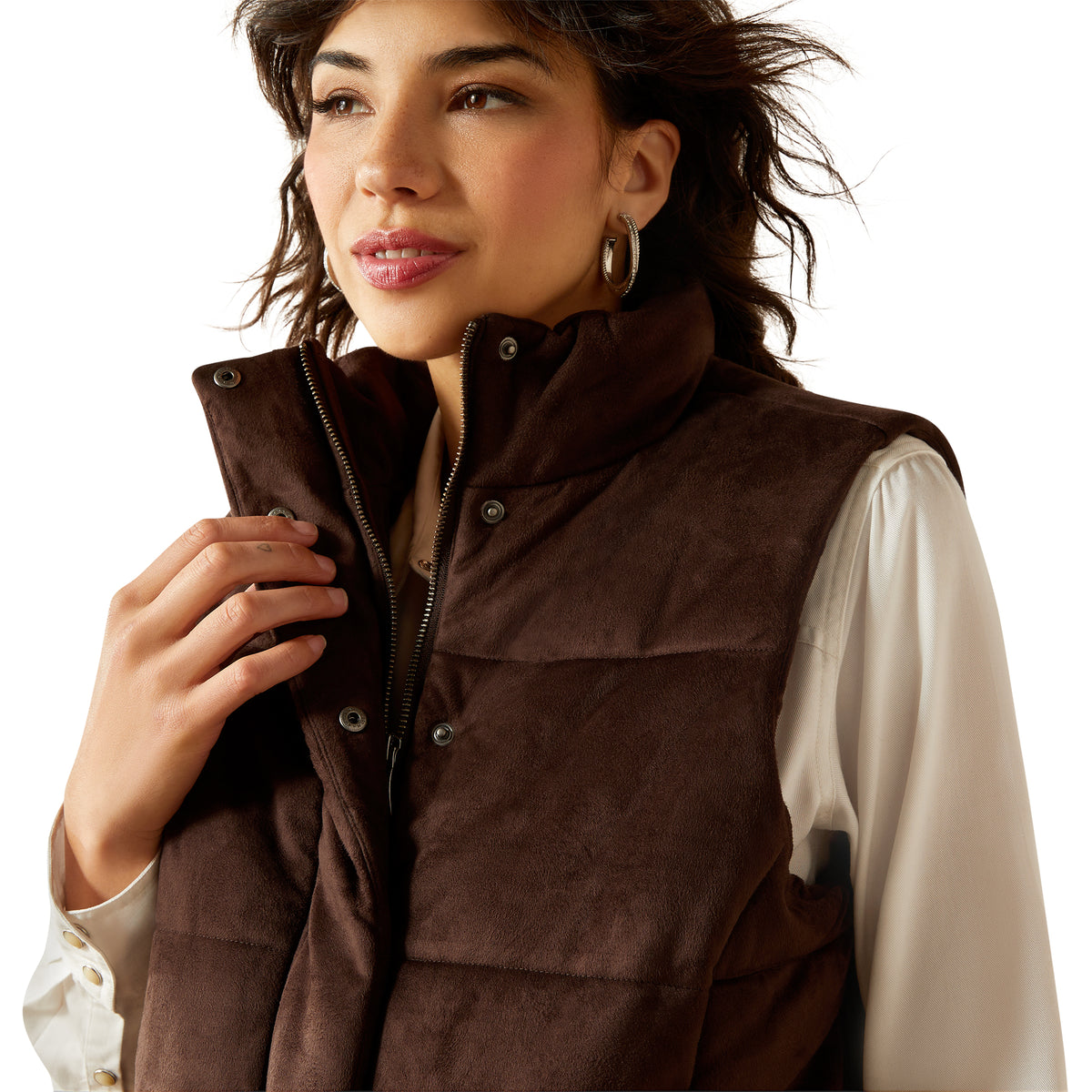 Woman wearing a brown vest over a white shirt on a white background