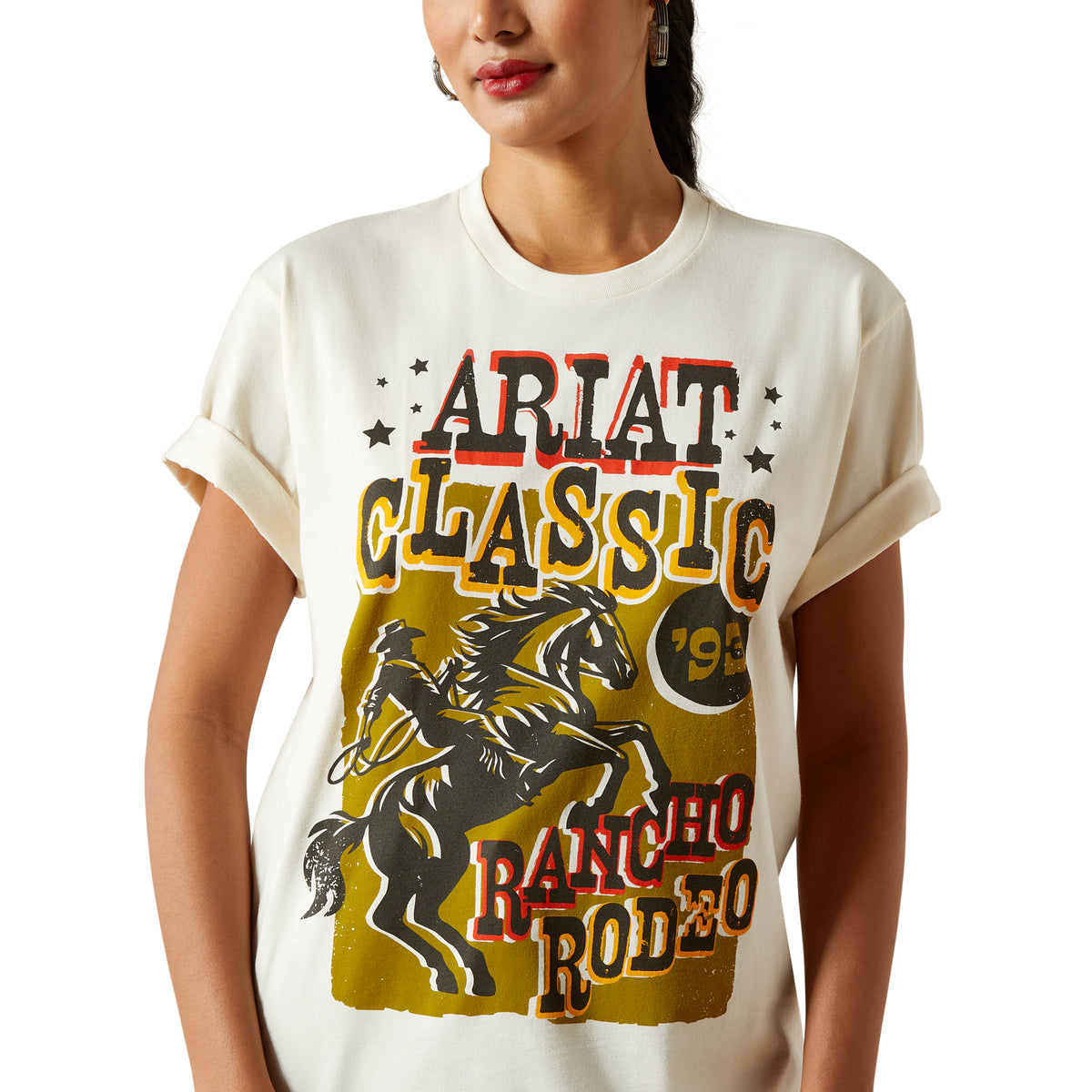 Ariat Women's Classic Rodeo T-Shirt. Person wearing a white t-shirt with 'Ariat Classic Rancho Rodeo' graphic design.