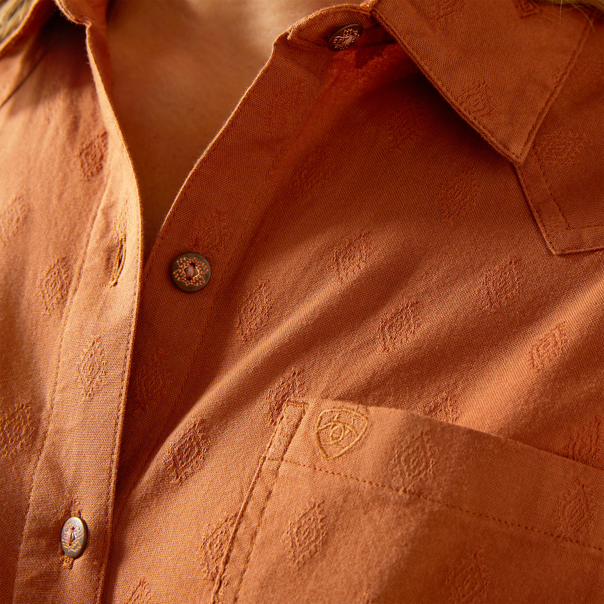 Close-up of a brown textured shirt with buttons