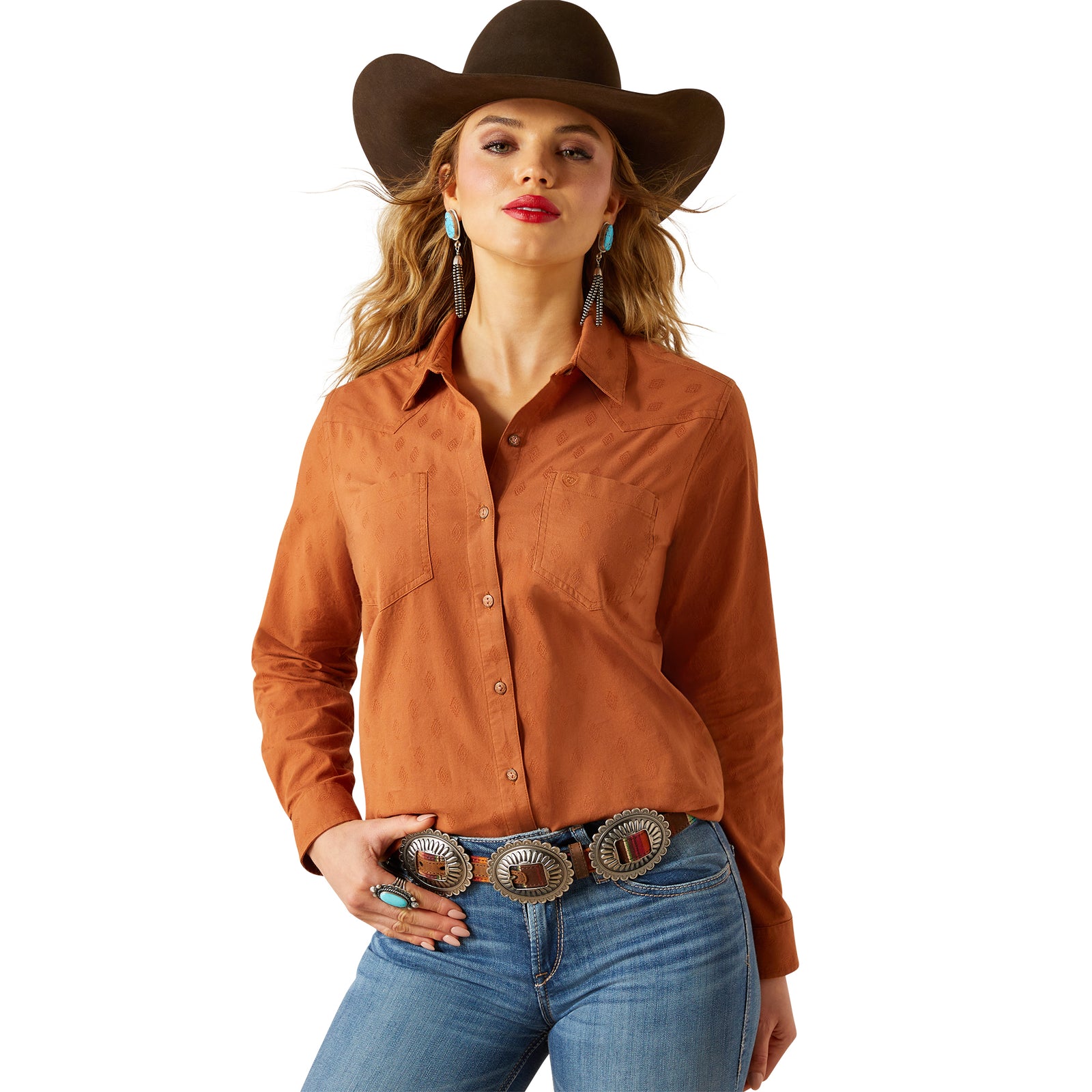 Woman wearing a brown cowboy hat, orange shirt, and blue jeans on a white background