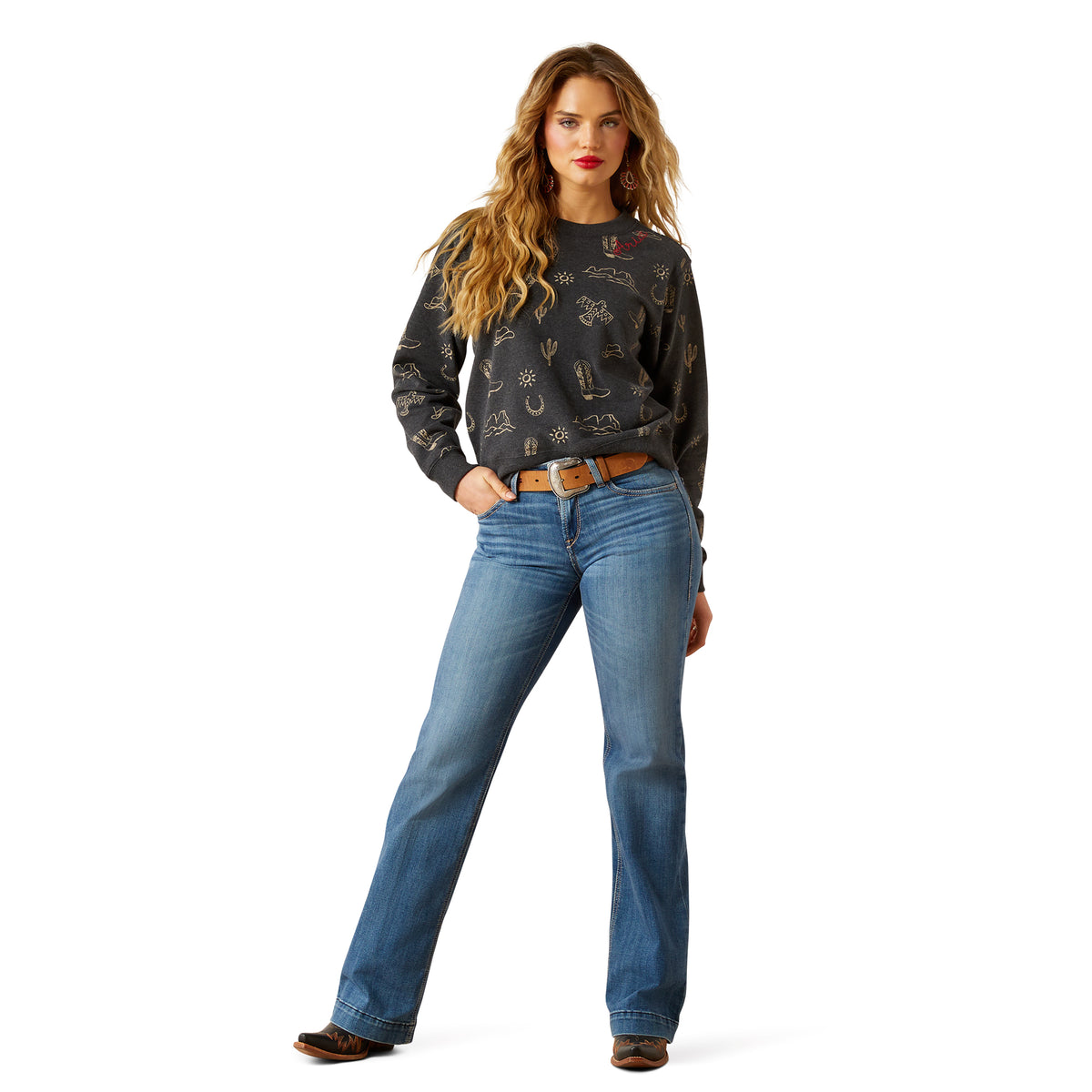 Woman wearing a patterned sweater and blue jeans on a white background
