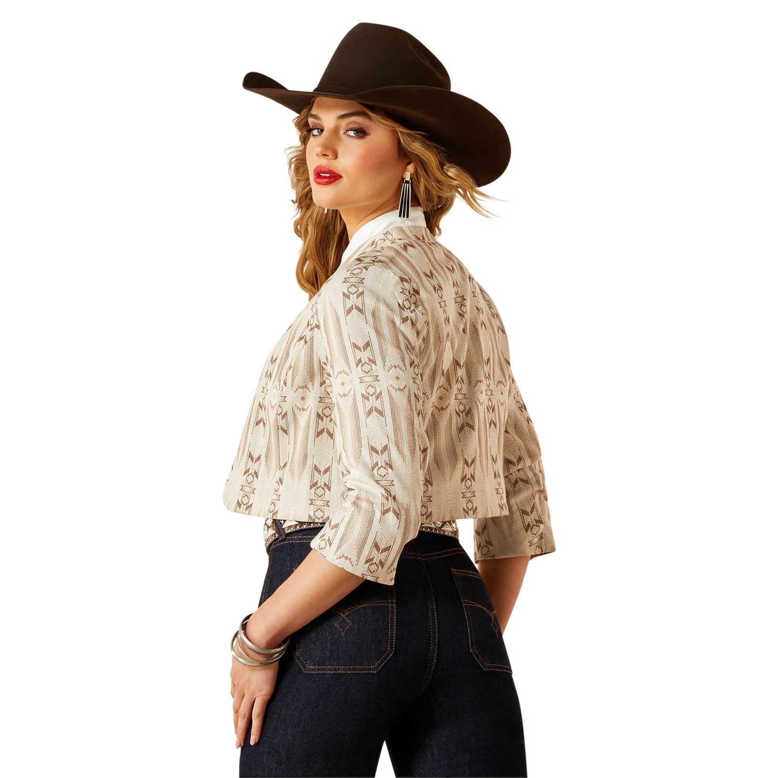 Woman wearing a cowboy hat and patterned blouse on a white background