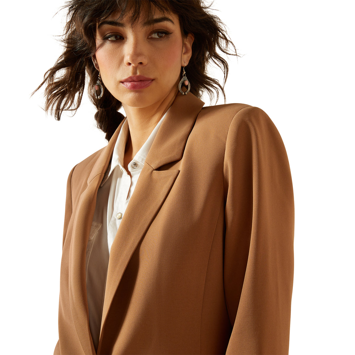 Woman wearing a brown blazer over a white shirt on a white background