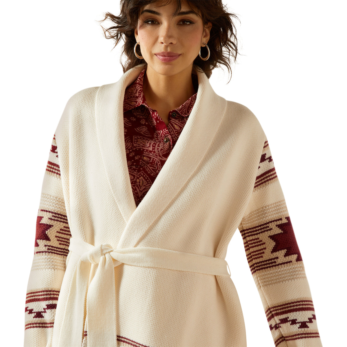 Woman wearing a cream-colored robe with red and brown patterned sleeves on a white background