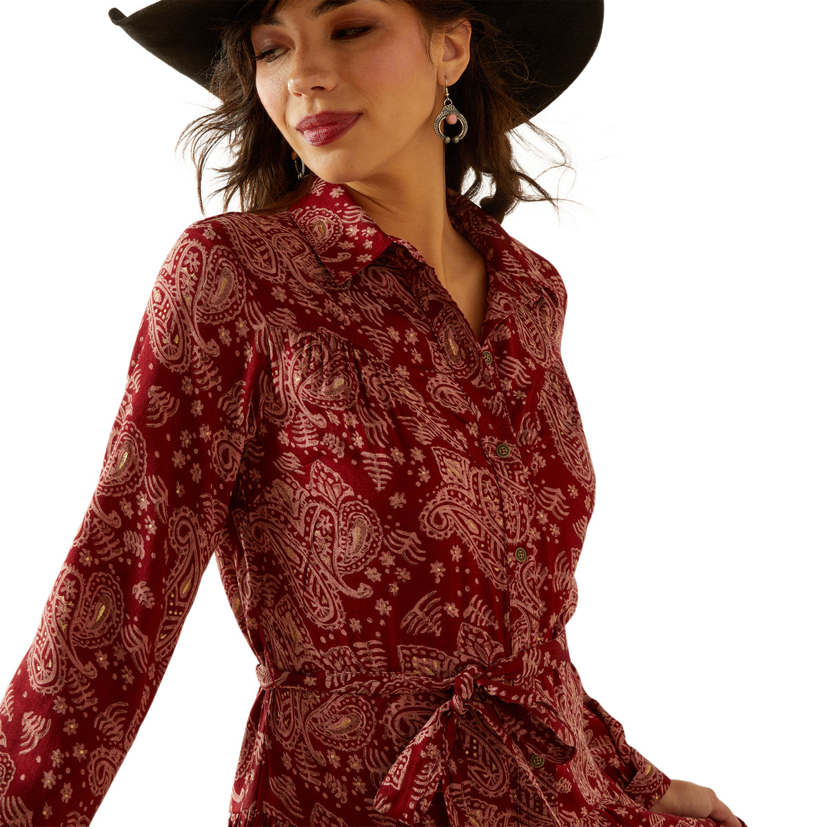 Woman wearing a red patterned dress with a white background