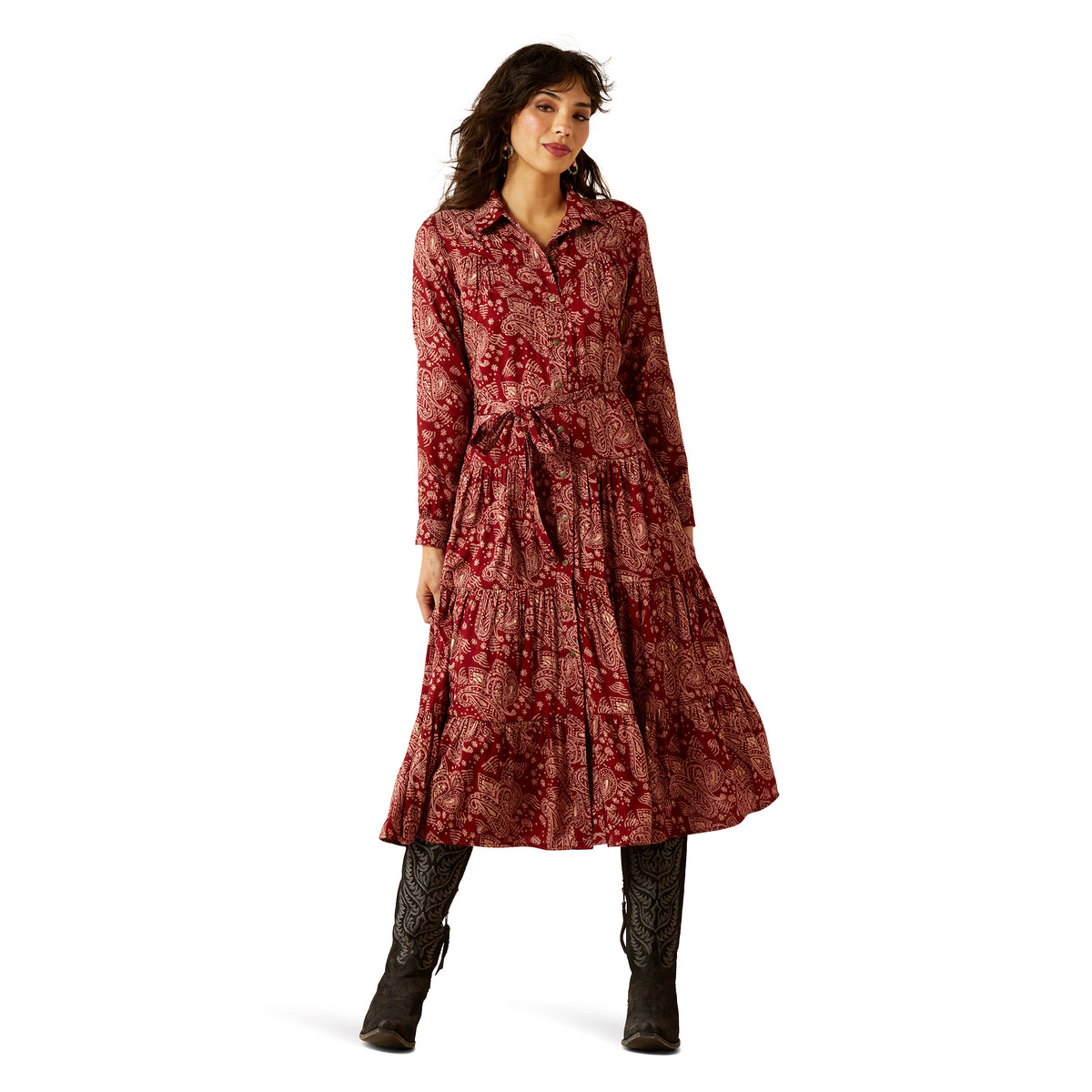 Woman wearing a red patterned dress with long sleeves on a white background