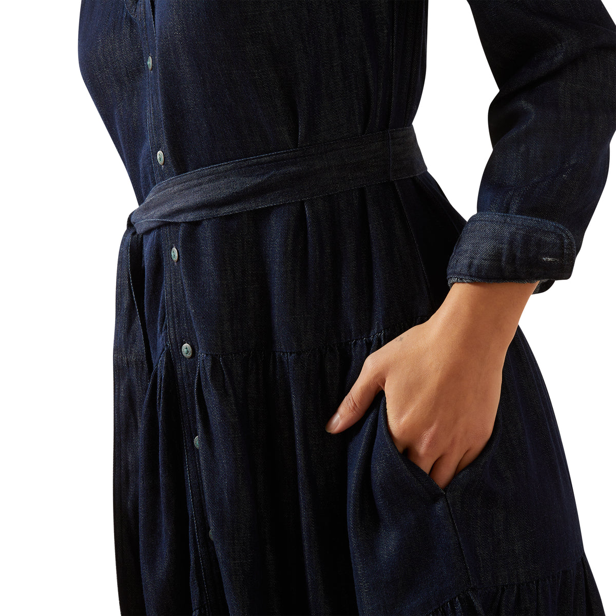 Navy blue dress with a belt and a hand in the pocket on a white background