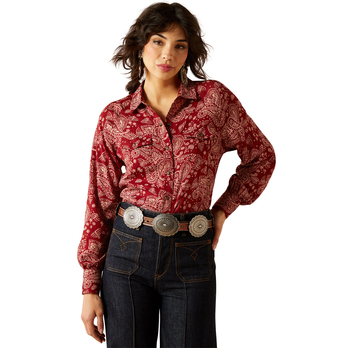 Woman wearing a red patterned shirt and blue jeans on a white background