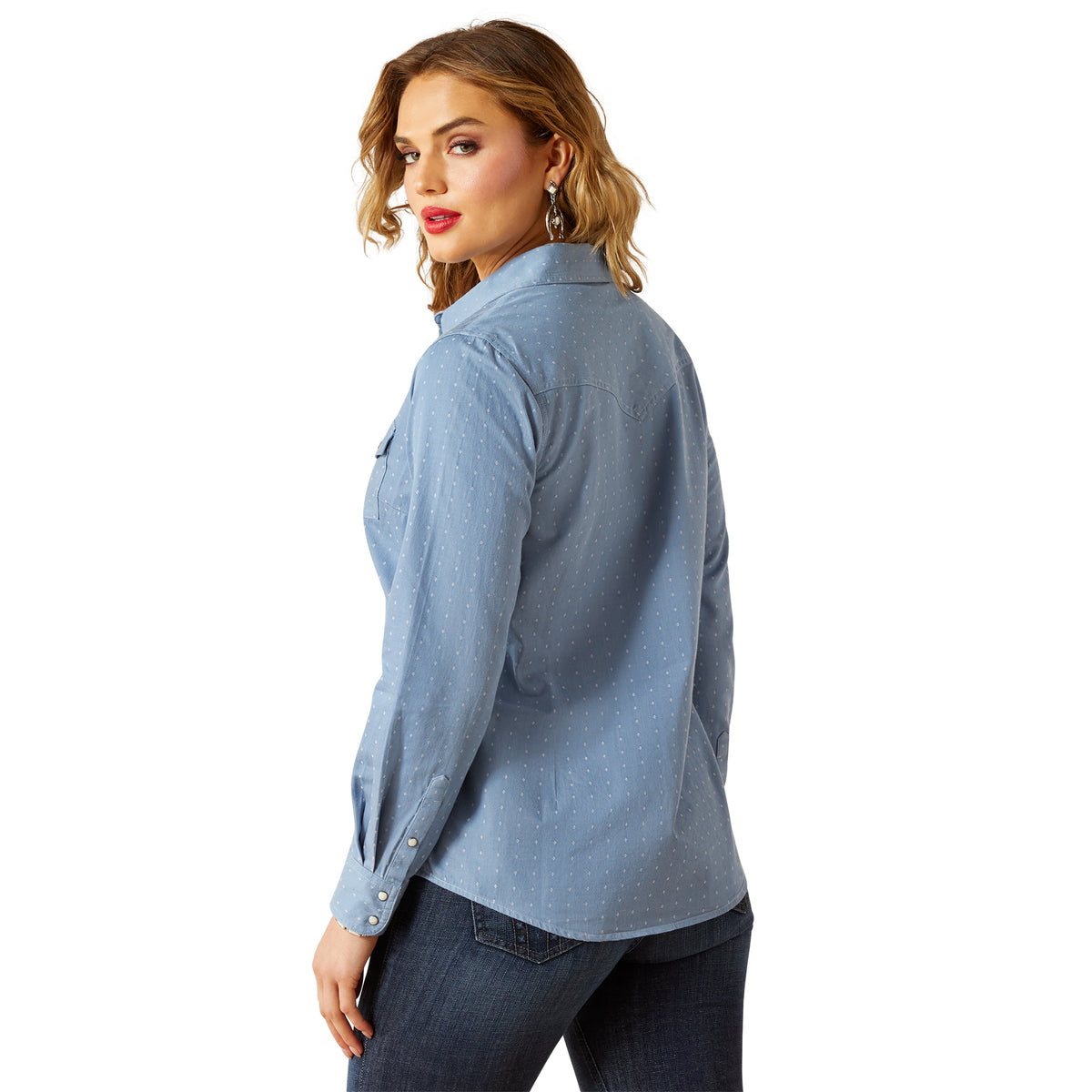 Woman wearing a light blue button-up shirt on a white background