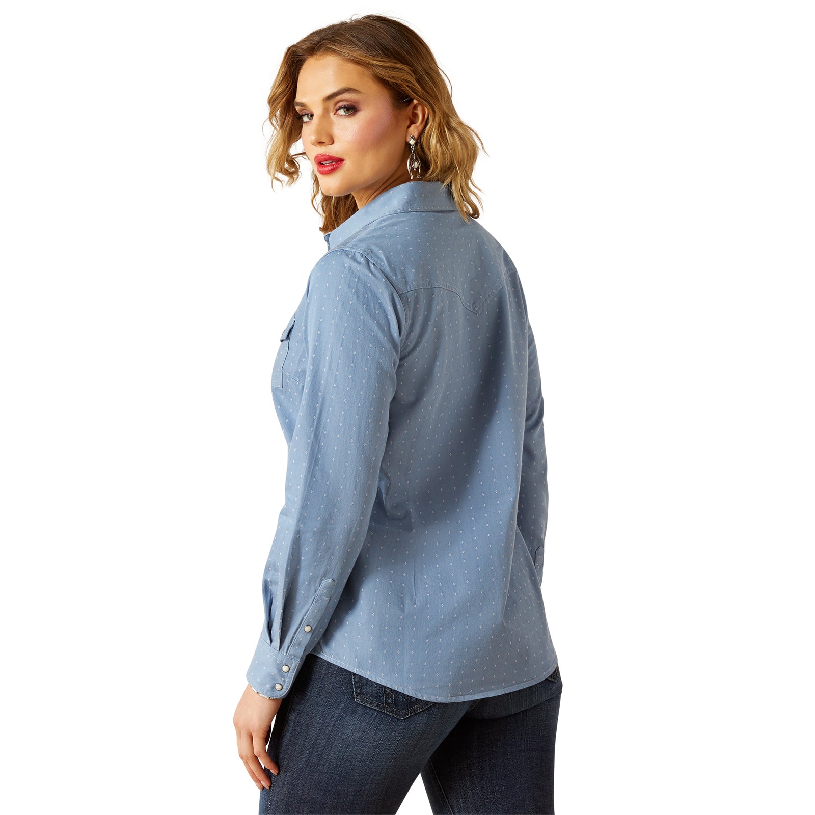 Woman wearing a light blue button-up shirt on a white background