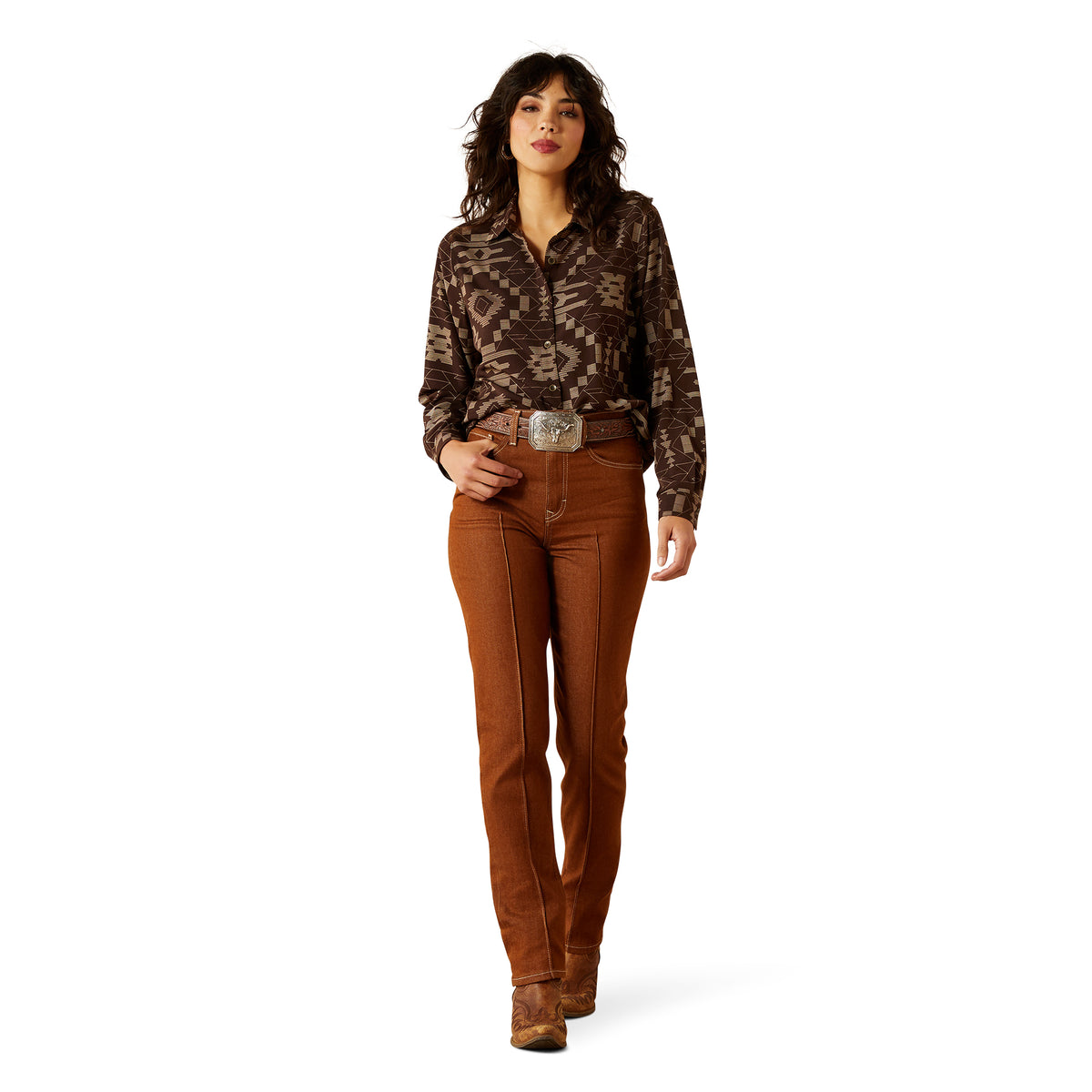 Woman wearing a patterned blouse and brown pants on a white background