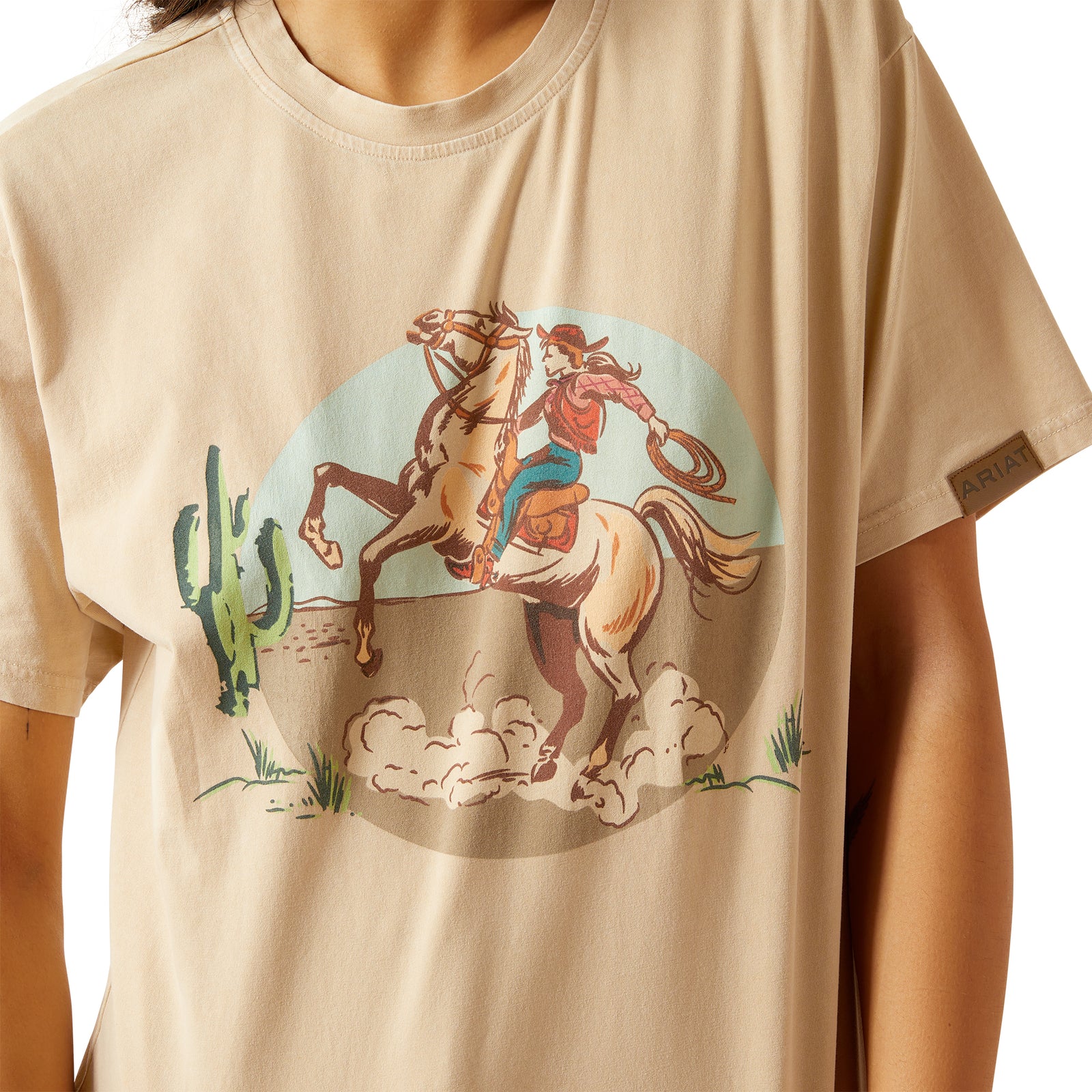 Woman wearing a beige t-shirt with a graphic design on a white background