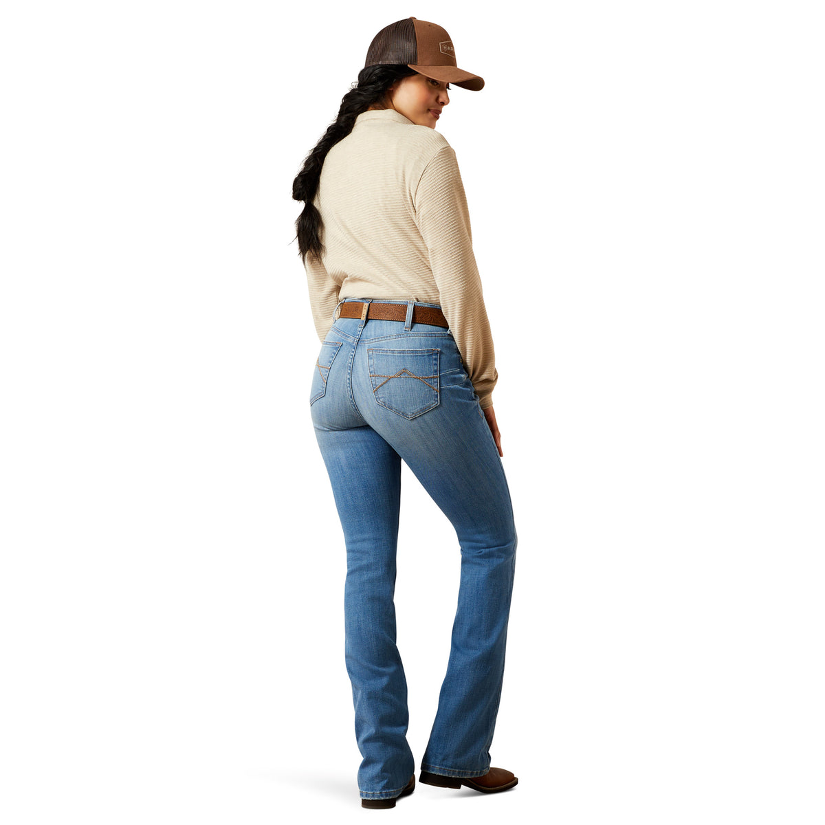 Person wearing blue jeans and a beige shirt with a brown cap on a white background
