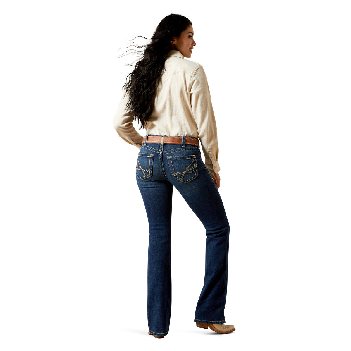 Woman wearing blue jeans and a cream shirt on a white background