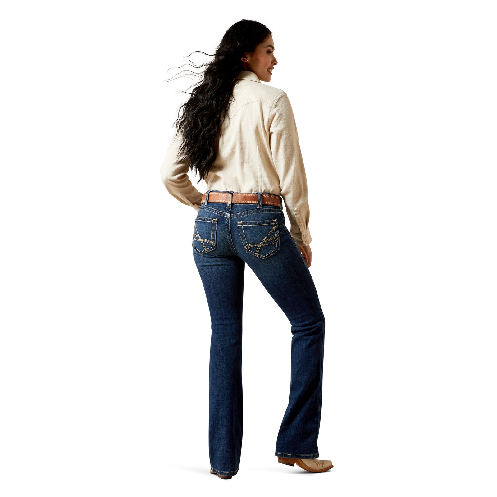 Person wearing blue jeans with a white background