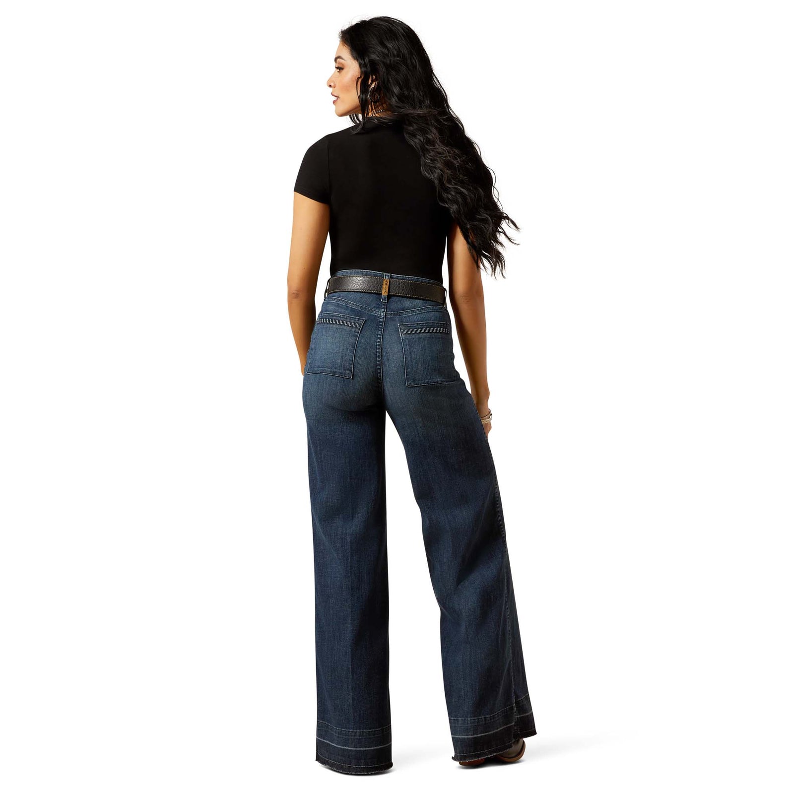 Person wearing blue jeans on a white background
