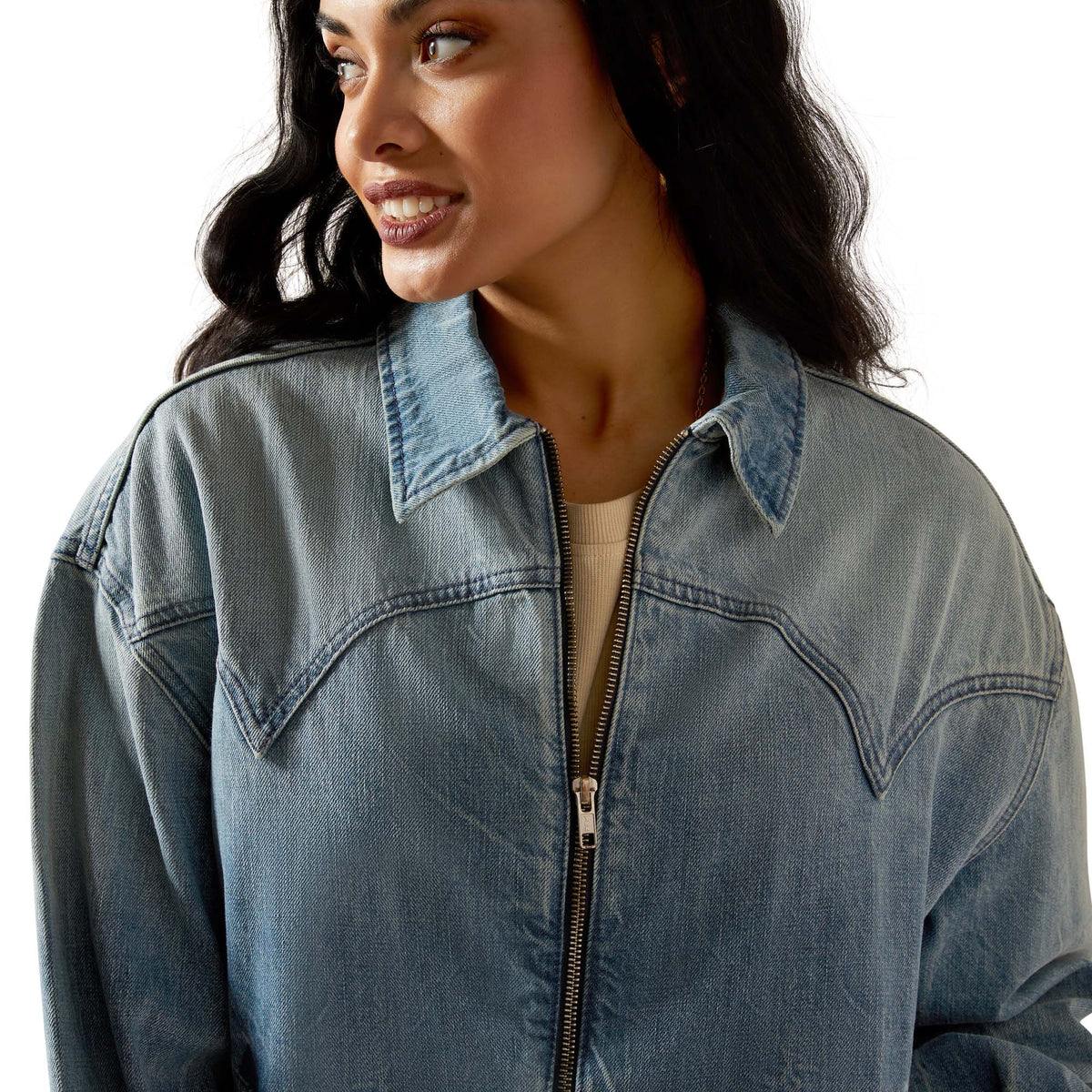 Woman wearing a blue denim jacket on a white background