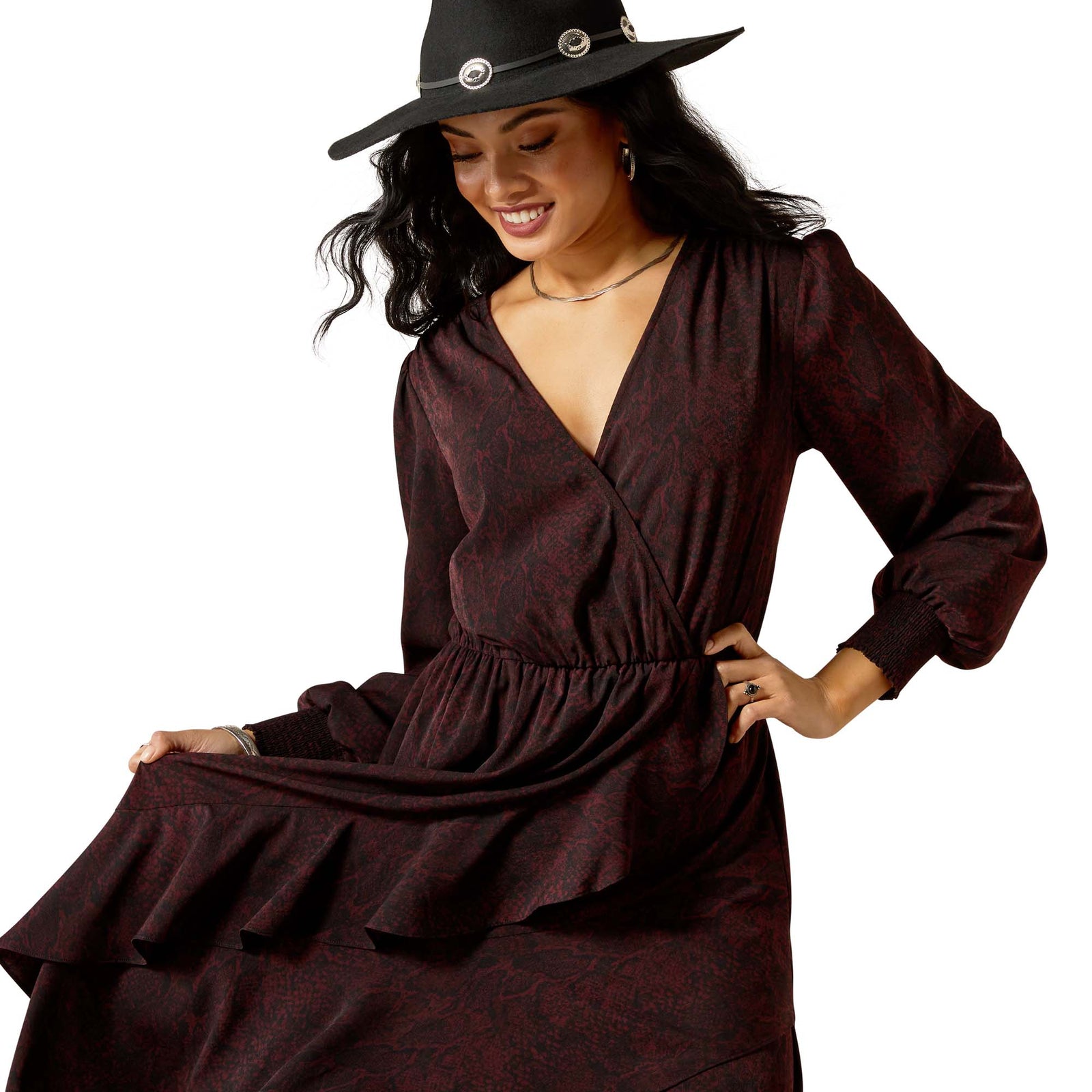 Woman wearing a dark brown dress and black hat on a white background