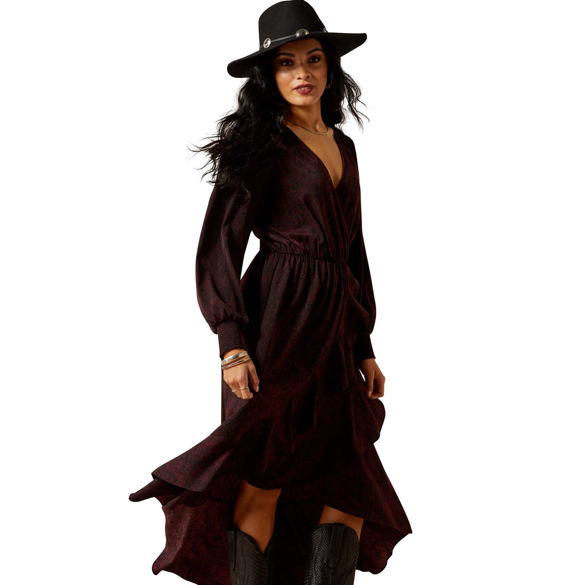 Woman wearing a dark brown dress and black hat on a white background