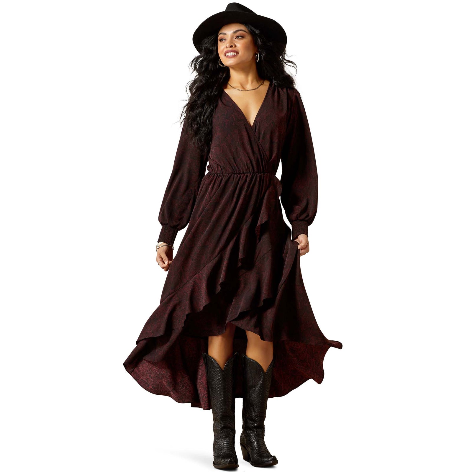 Woman wearing a long brown dress and black boots on a white background