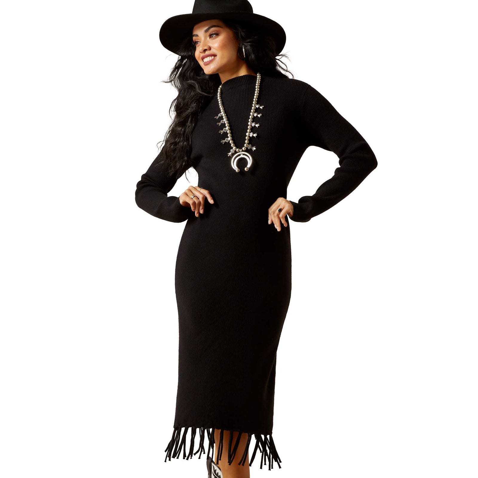Woman wearing a black dress with fringe details and a matching hat on a white background