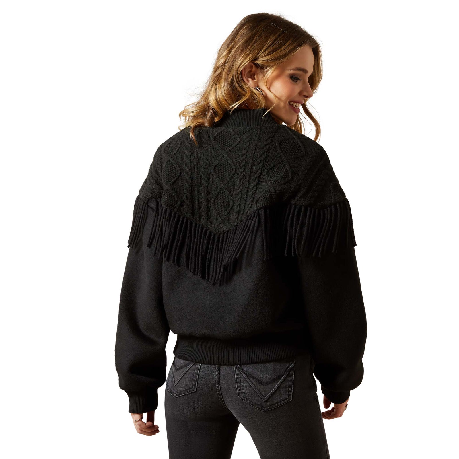 Person wearing a black fringed jacket on a white background